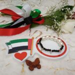 Handmade bracelet of black beads,white big pearls and small star shaped flag colors pieces in a special design.