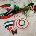 Handmade bracelet of black, green and red beads with white pearls.