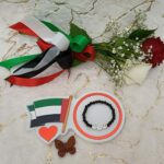 Handmade bracelet of black beads and simile faces by UAE flag colors